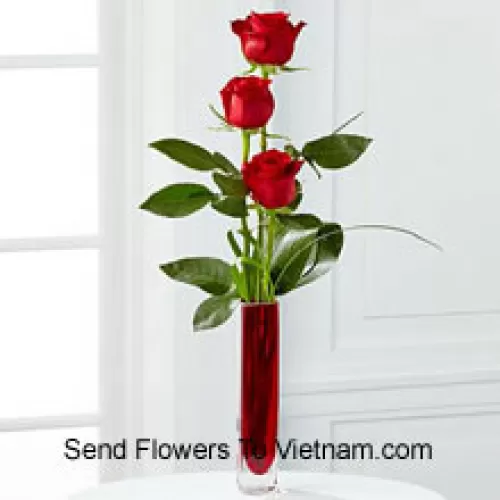 Drei rote Rosen in einer roten Reagenzglasvase (Wir behalten uns das Recht vor, die Vase bei Nichtverfügbarkeit zu ersetzen. Begrenzte Stückzahl)